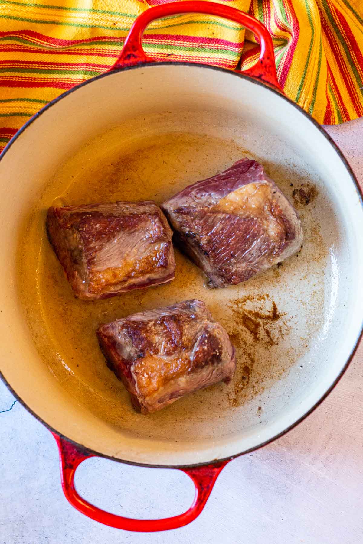 Searring short ribs in a dutch oven.