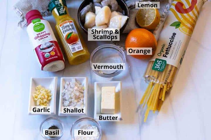 Ingredients to make shrimp scallop pasta with orange cream sauce.