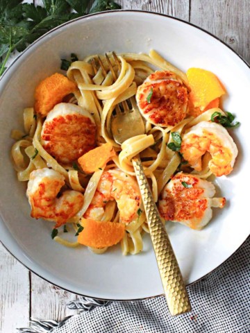 seared shrimp and scallops over fettuccini pasta with orange cream sauce