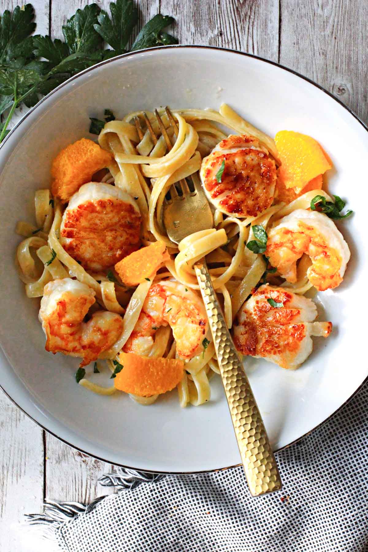 seared shrimp and scallops over fettuccini pasta with orange cream sauce.