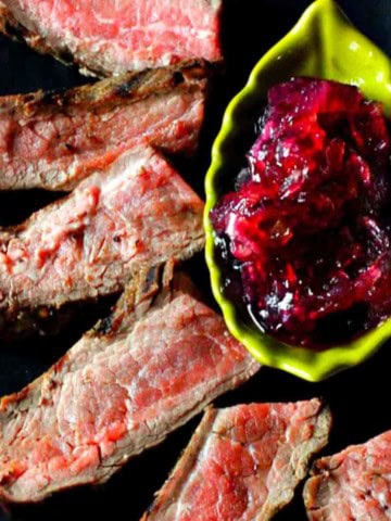 Cast iron skillet flank steak served with onion chutney.