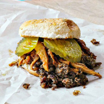 Kickin Chicken Sandwich with Sausage and pickles.