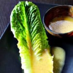 Dijon Vinaigrette on a leaf of Romaine Lettuce.
