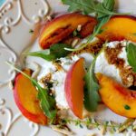 Grilled peach salad with arugula and goat cheese