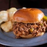 Sloppy joes for a crowd. A sloppy joe served on a plate with potato chips.