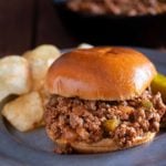 Sloppy Joes on a bun with potato chips on the side.