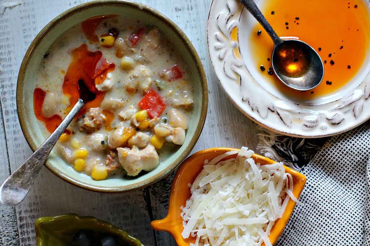 Creamy white bean chicken chili with parmesan cheese and chili oil.
