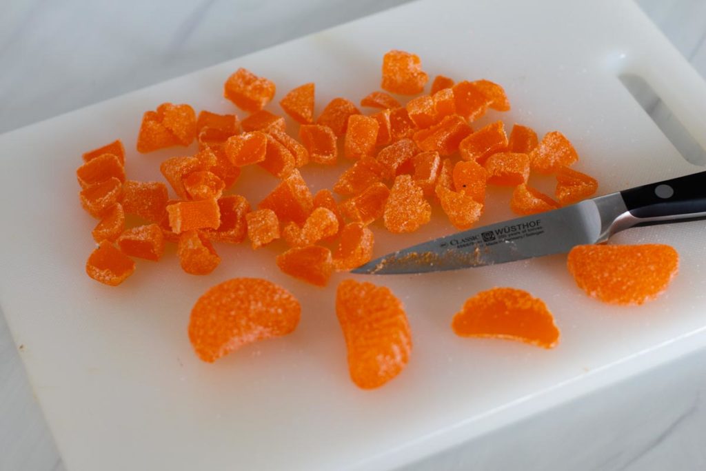 Cutting orange slice candy into pieces