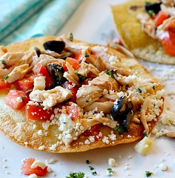 Homemade chicken tostada recipe with feta and olives. Easy Mexican Dish for a weeknight meal.