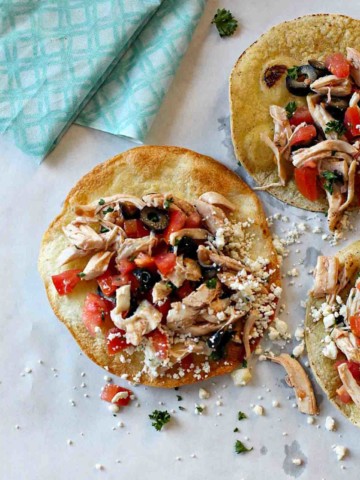 Zesty Chicken Tostadas with Feta Cheese, olives and tomatoes.