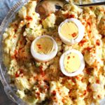 classic potato salad recipe topped with sliced hard boiled eggs