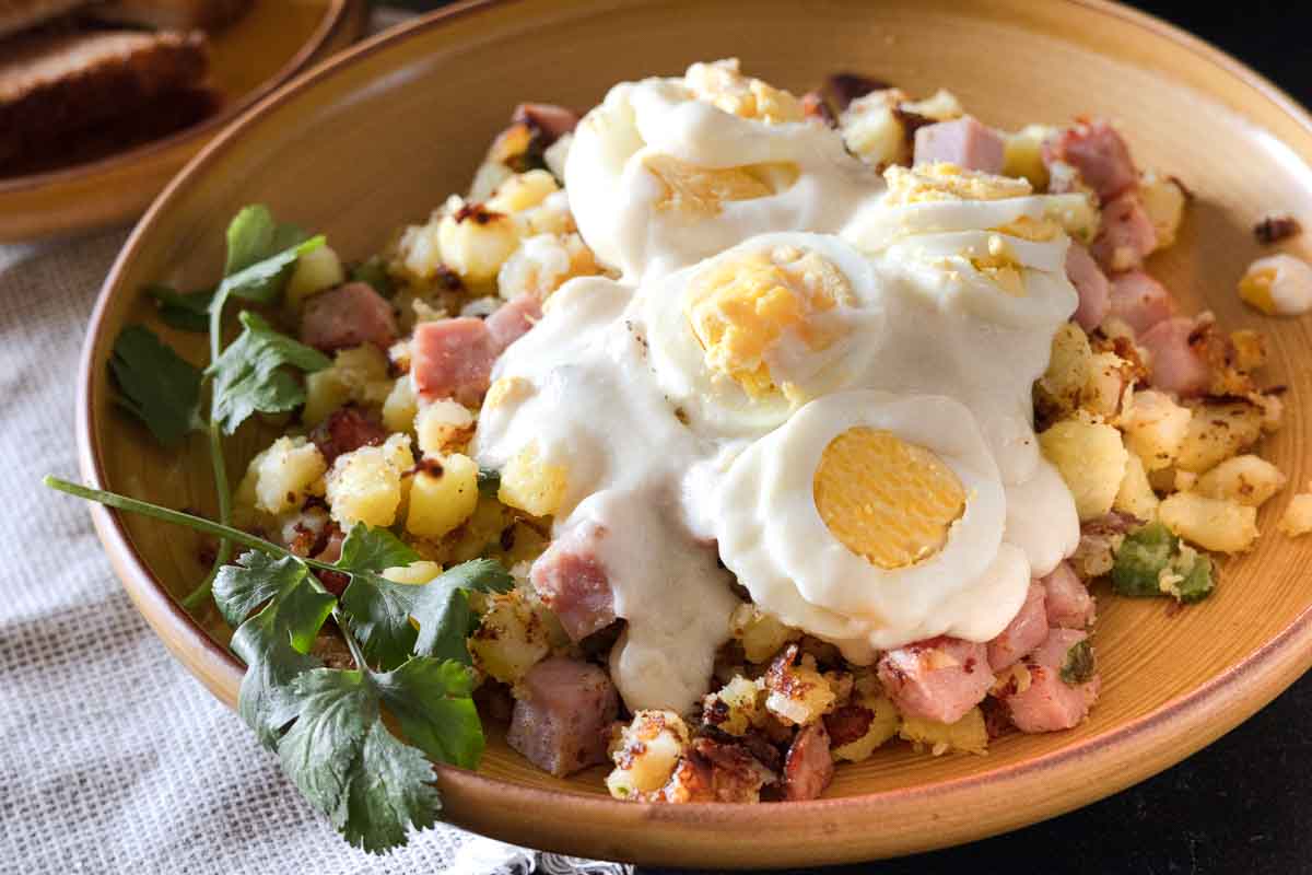 Ham Hash topped with mushroom cream sauce and topped with sliced hard boiled eggs.