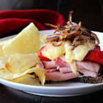Ham and Manchego cheese sandwich with roasted red bell peppers and caramelized onions