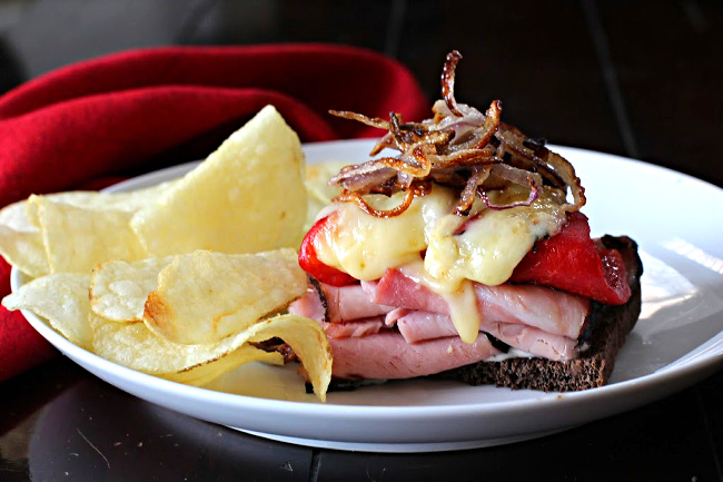 Ham and Manchego cheese sandwich with roasted red bell peppers and caramelized onions