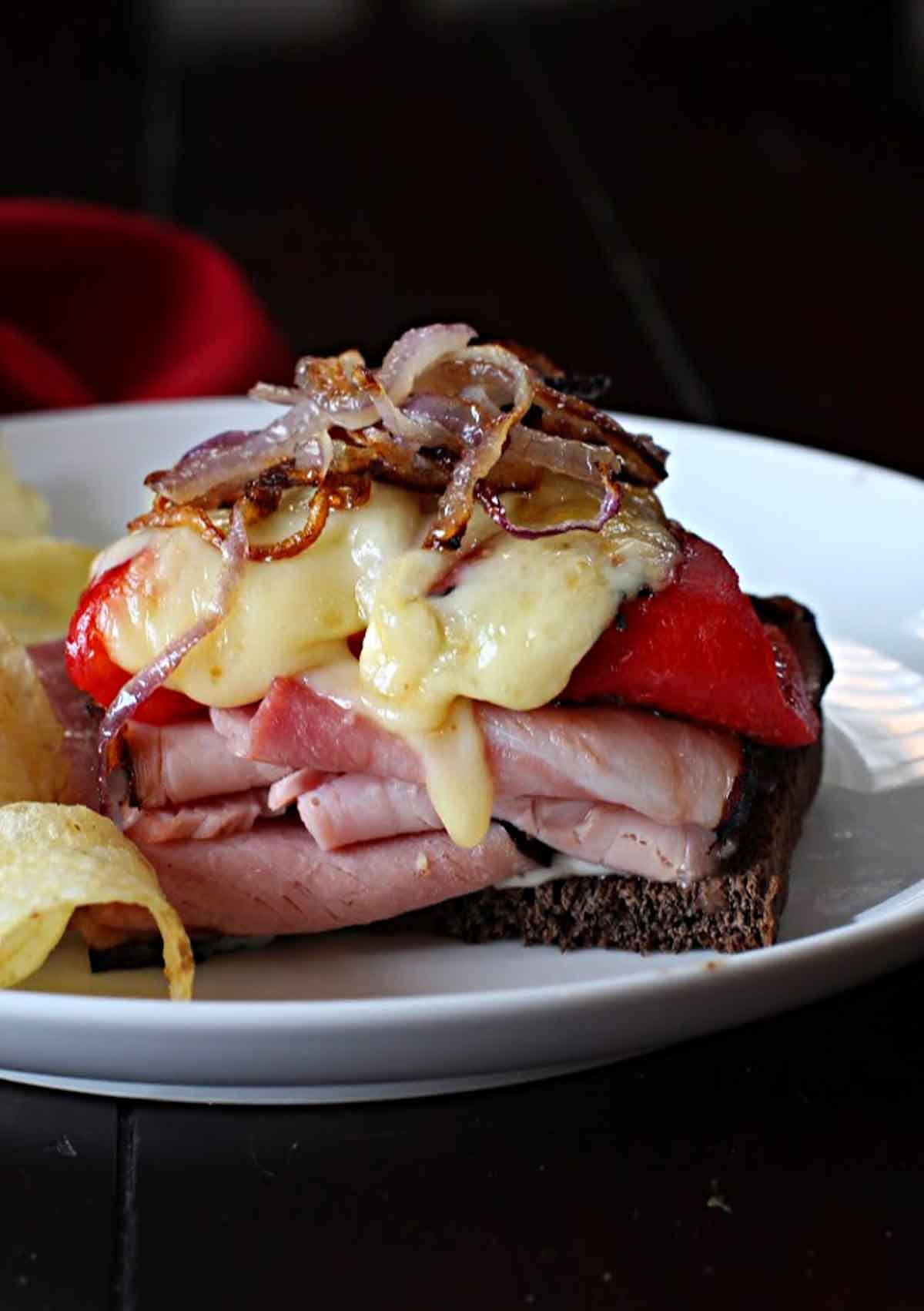 Ham and Manchego cheese sandwich with red bell peppers and caramelized onions