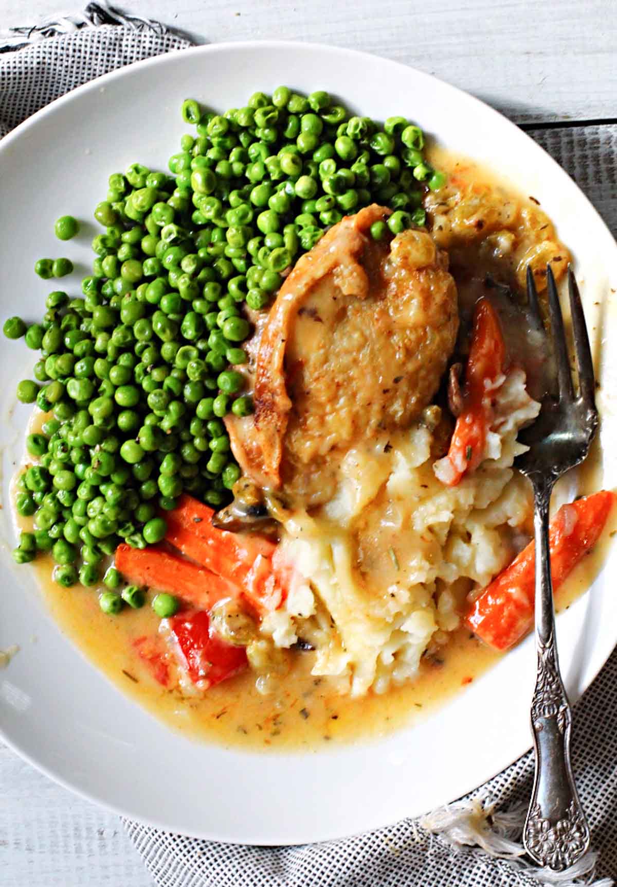 Chicken marengo chicken thighs served with peas and mashed potatoes