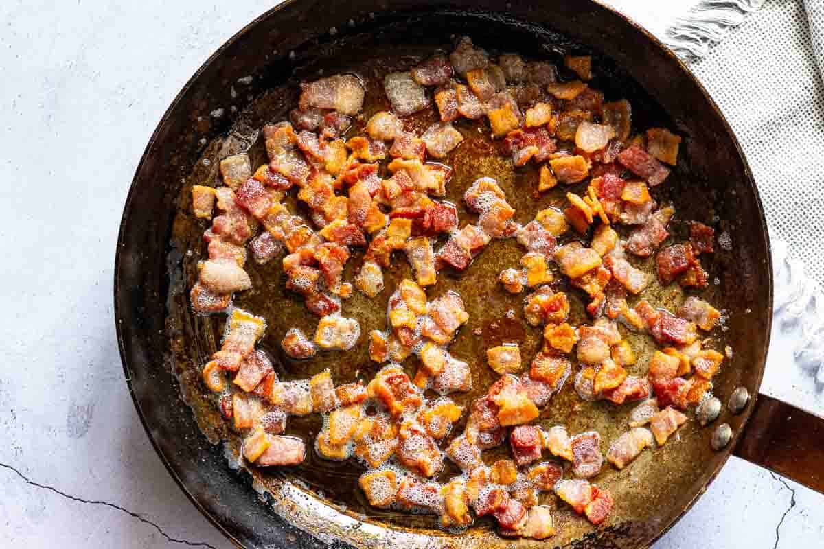 Cooking bacon to make Cheese tortellini pasta salad.