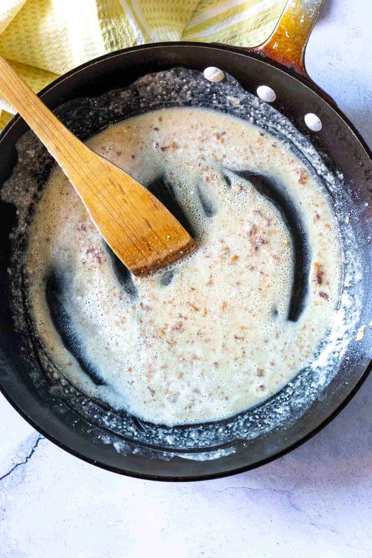 Making a roux in a fry pan to make fried chicken gravy