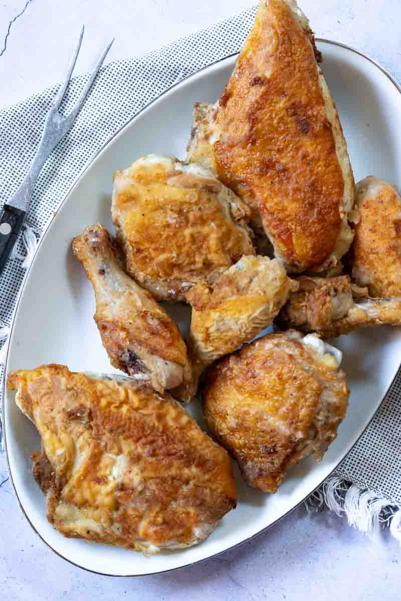 A platter of pan fried chicken pieces.