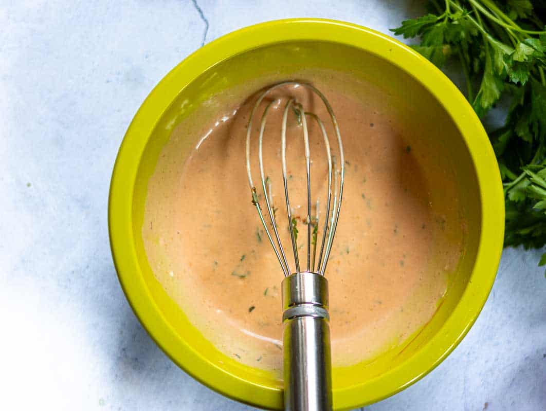 A bowl of tarragon dressing for BLT burgers.