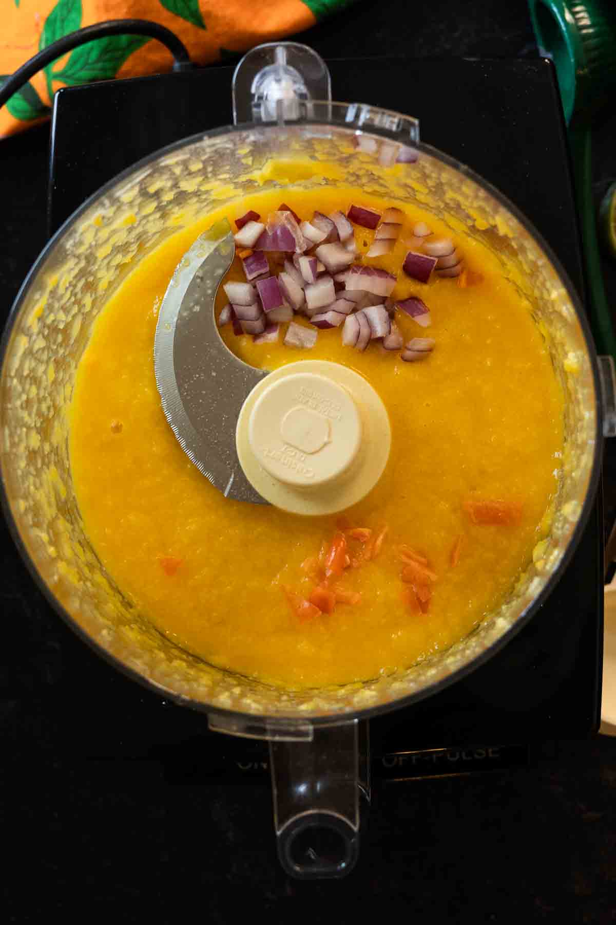 Step 3: Adding chopped onion and habanero pepper to make mango dressing.