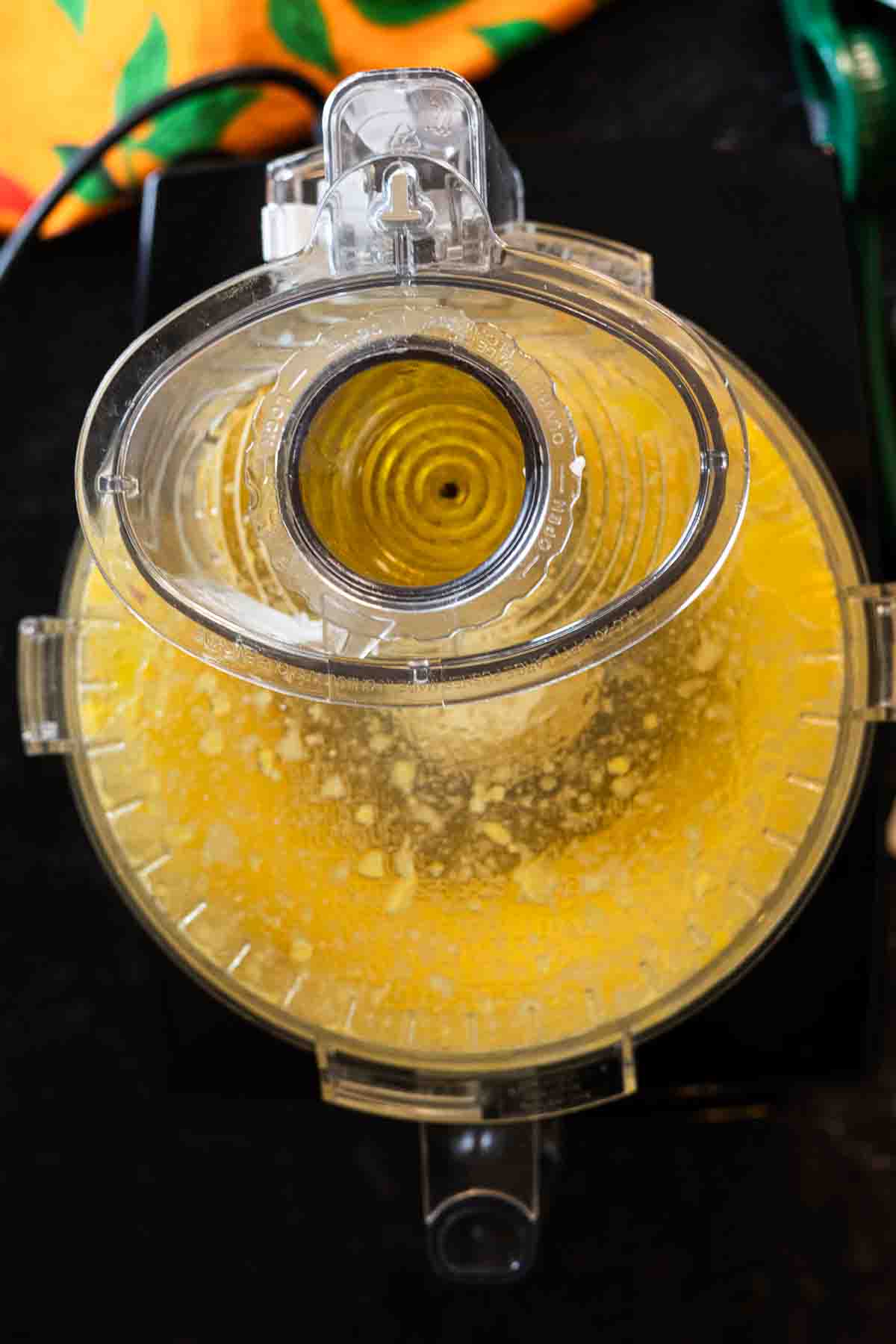 Step 4: Adding oil to food processor to make mango dressing.