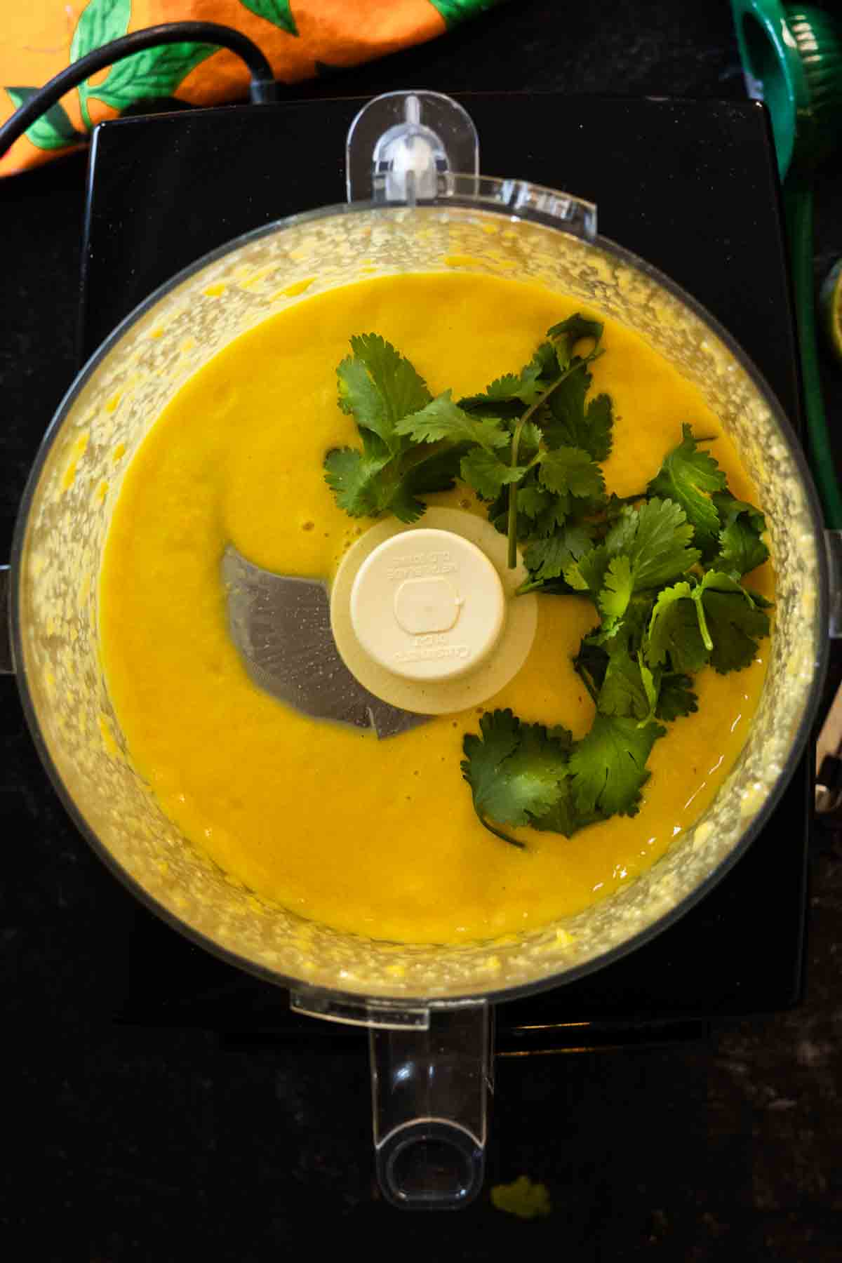Step 5: Adding cilantro to make mango dressing.