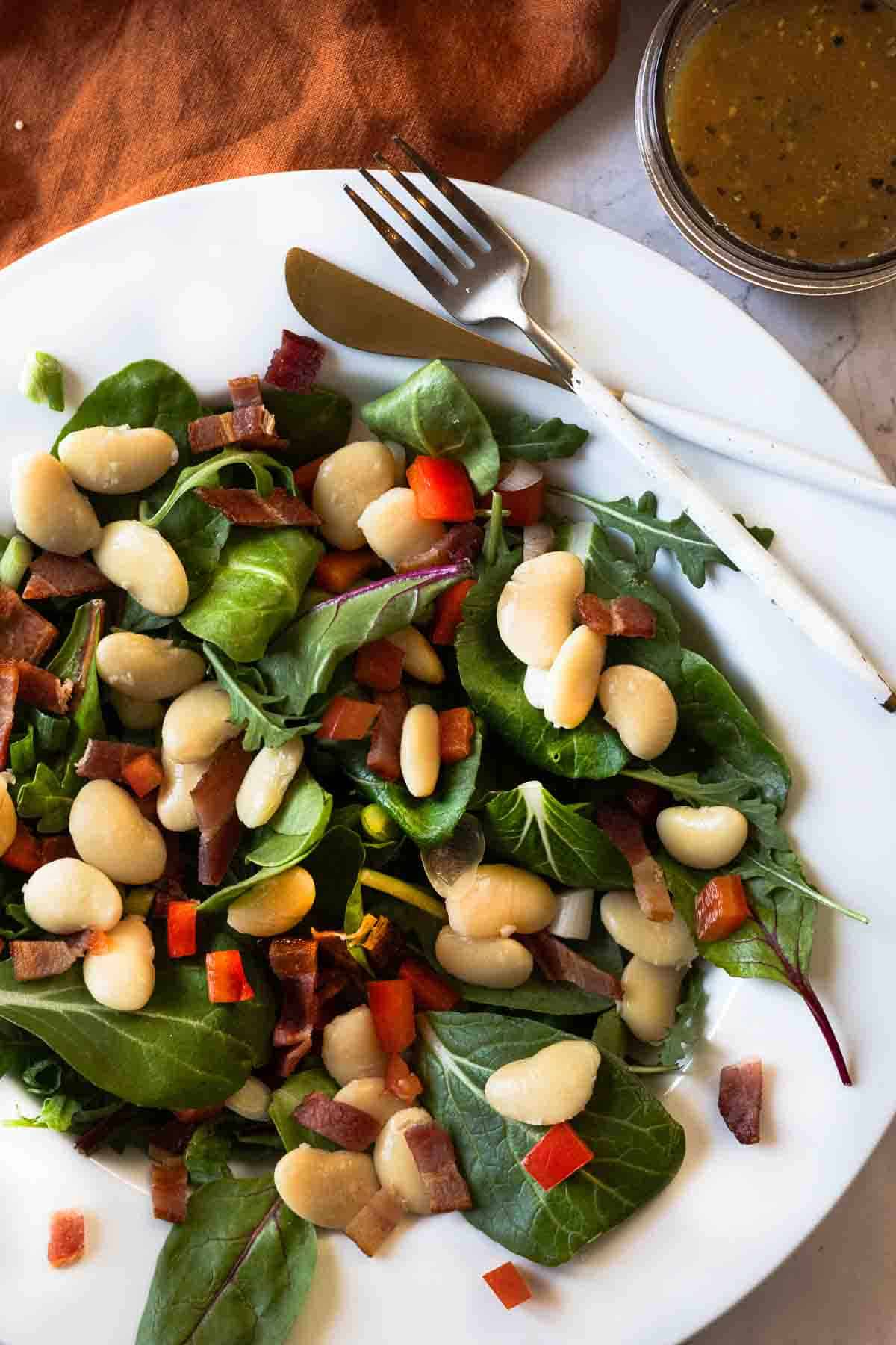 Butter bean salad served on a white platter bowl.