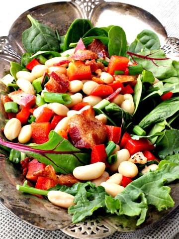 bacon, white bean, spinach salad recipe. With maple vinaigrette served on a silver platter