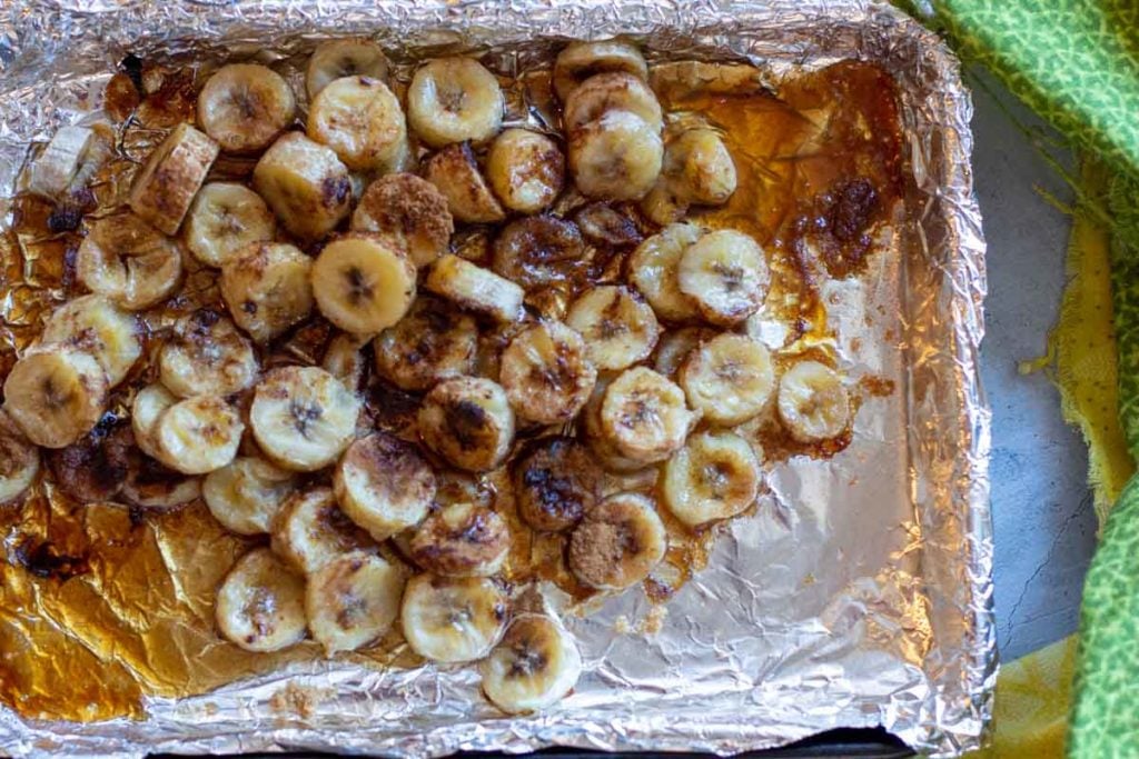Caramelized bananas on a sheet pan lined with foil.