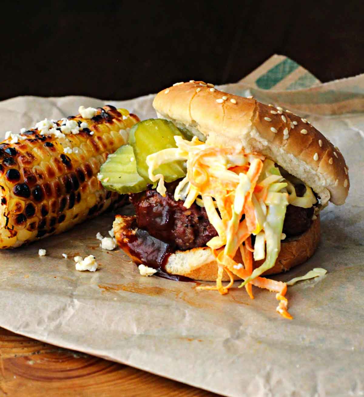 Bobby Flay Texas Burger topped with cole slaw and BBQ sauce served with grilled corn