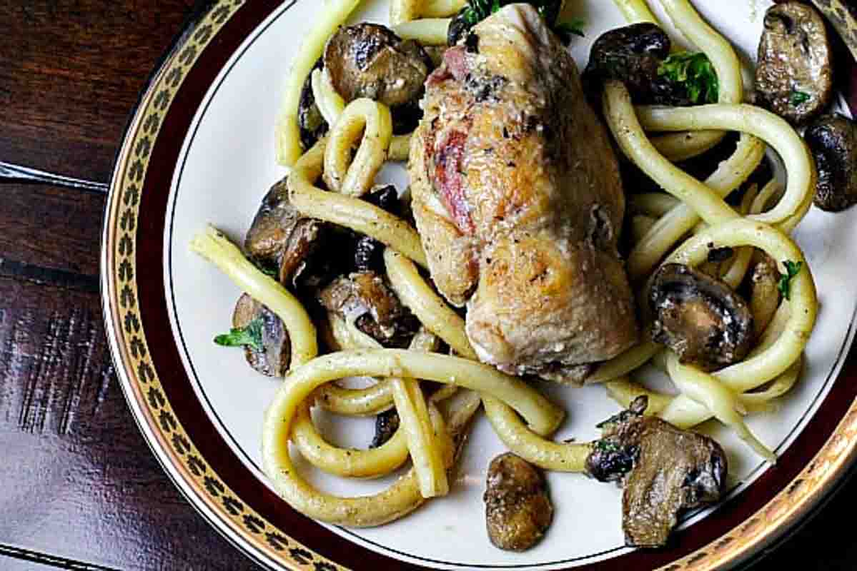 Chicken galliano with mushrooms, served with pasta.