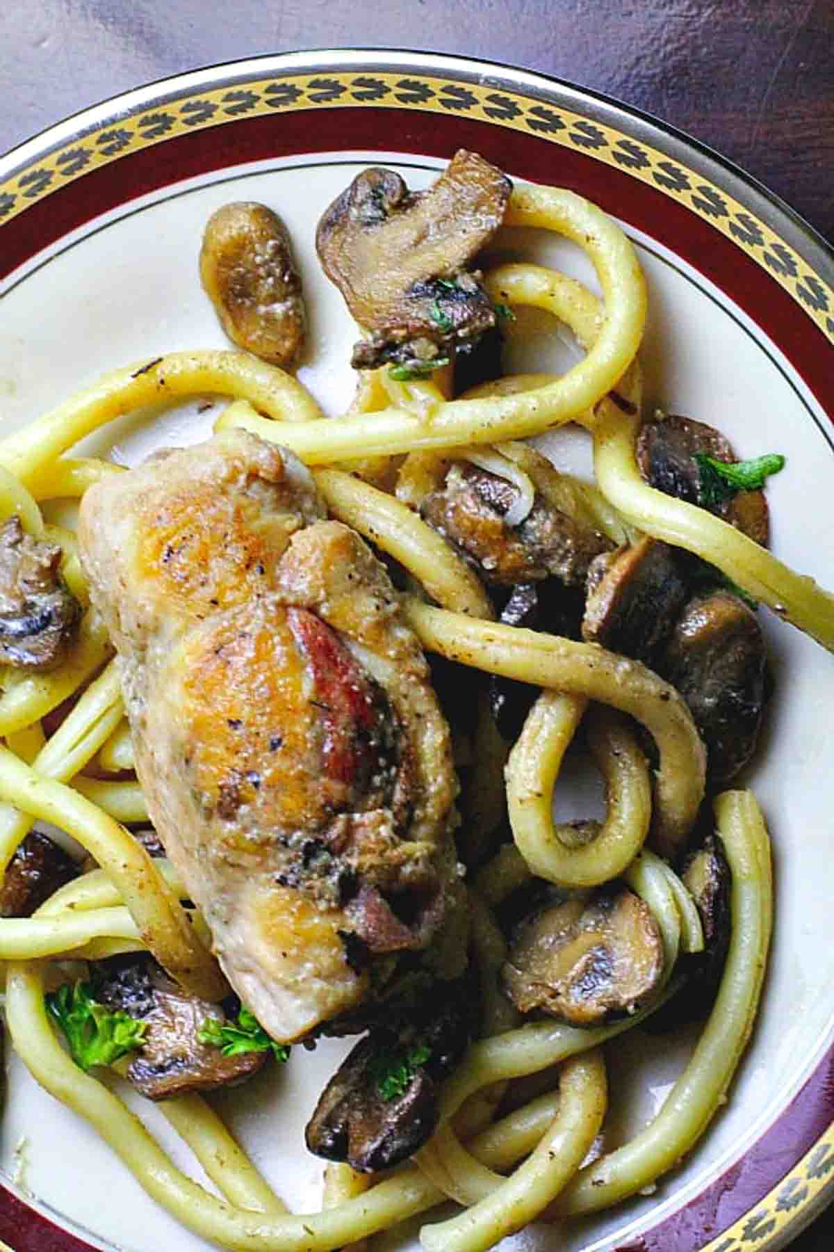 Chicken galliano with mushrooms served with pasta.