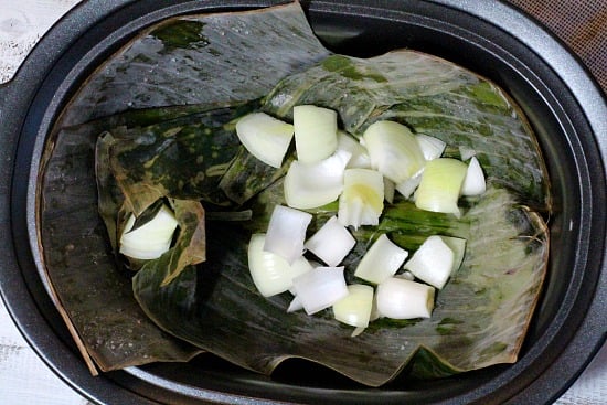 Pork Roast cooked in the slow cooker on banana leaves and onion. A great beginning to pulled pork sandwiiches.