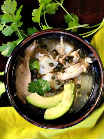 Columbian chicken and potato soup with avocado garnished with cilantro.