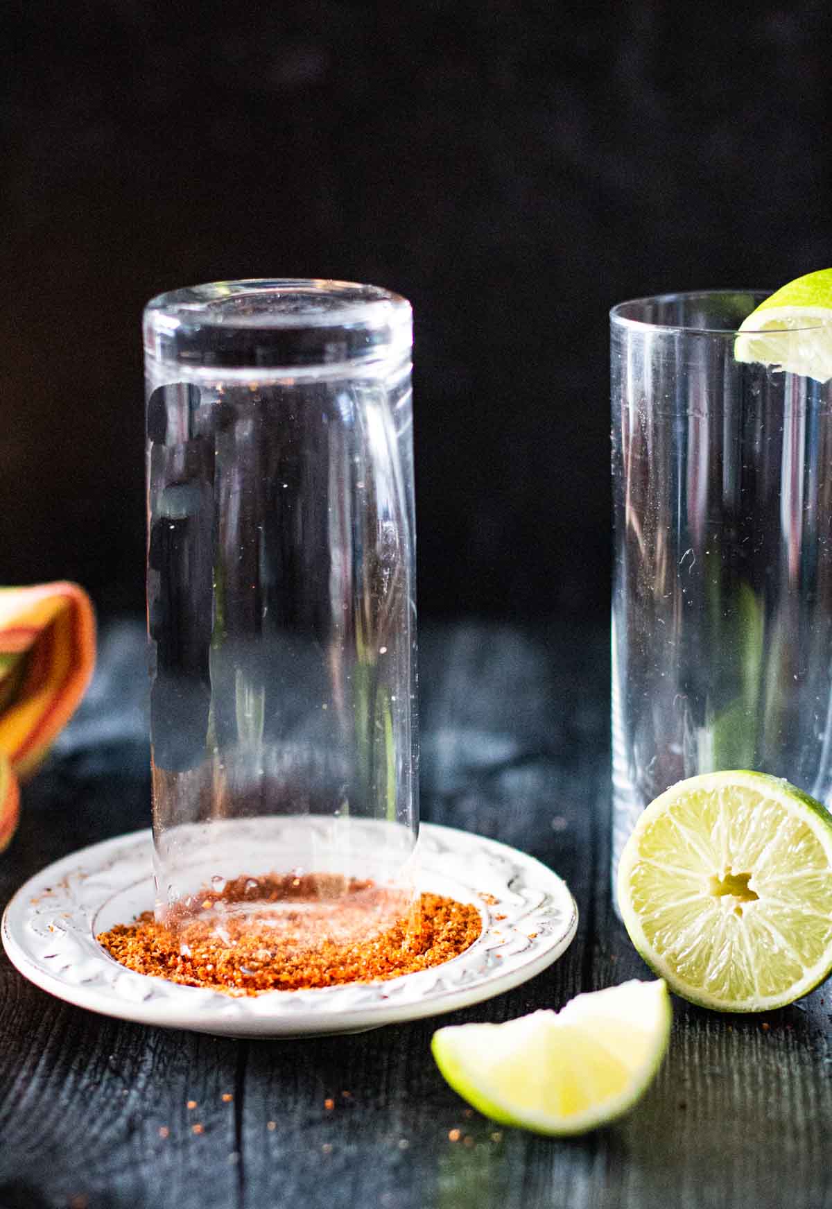 Rimming glasses with tajin seasoning to make micheladas.