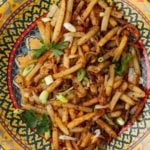 Turkish fries seasoned with aleppo pepper and served in a colorful bowl