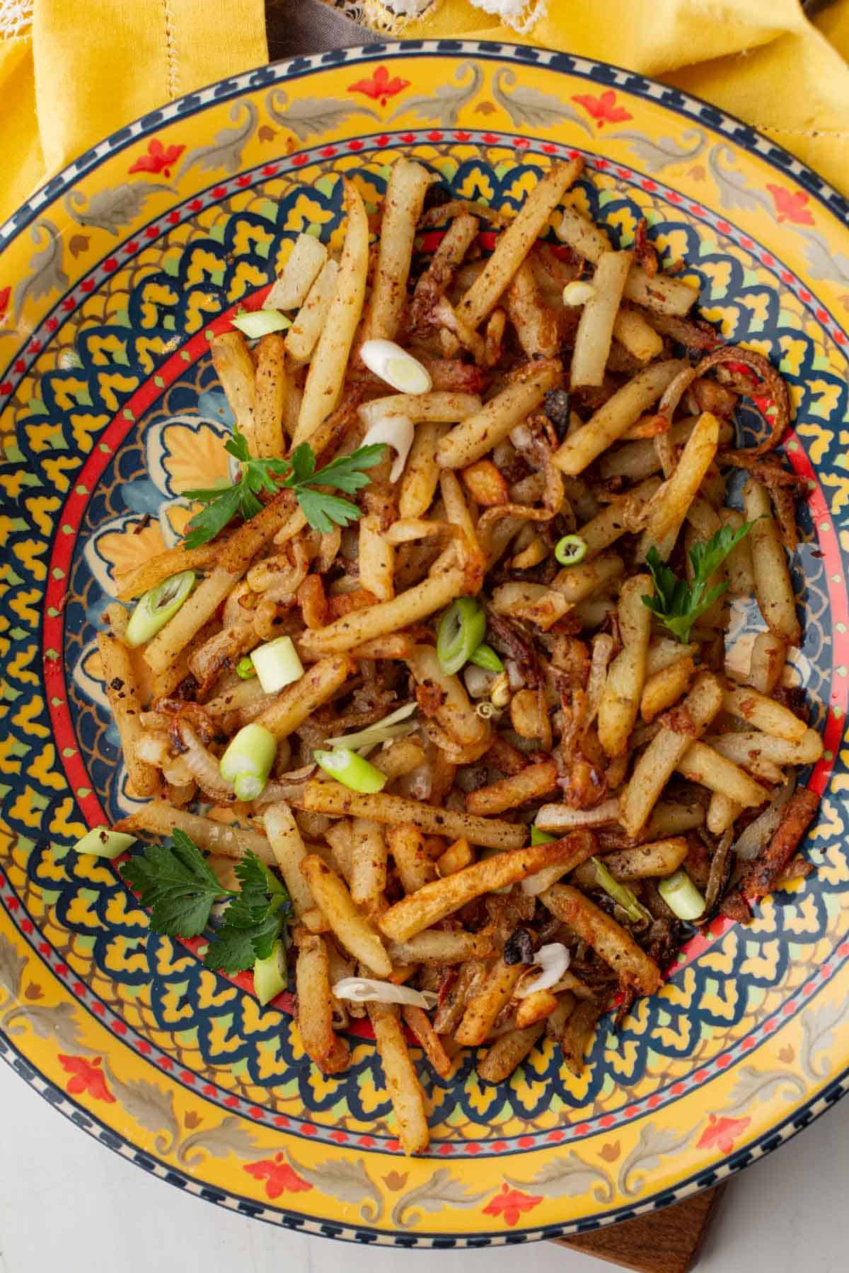 Turkish fries seasoned with aleppo pepper and served in a colorful bowl