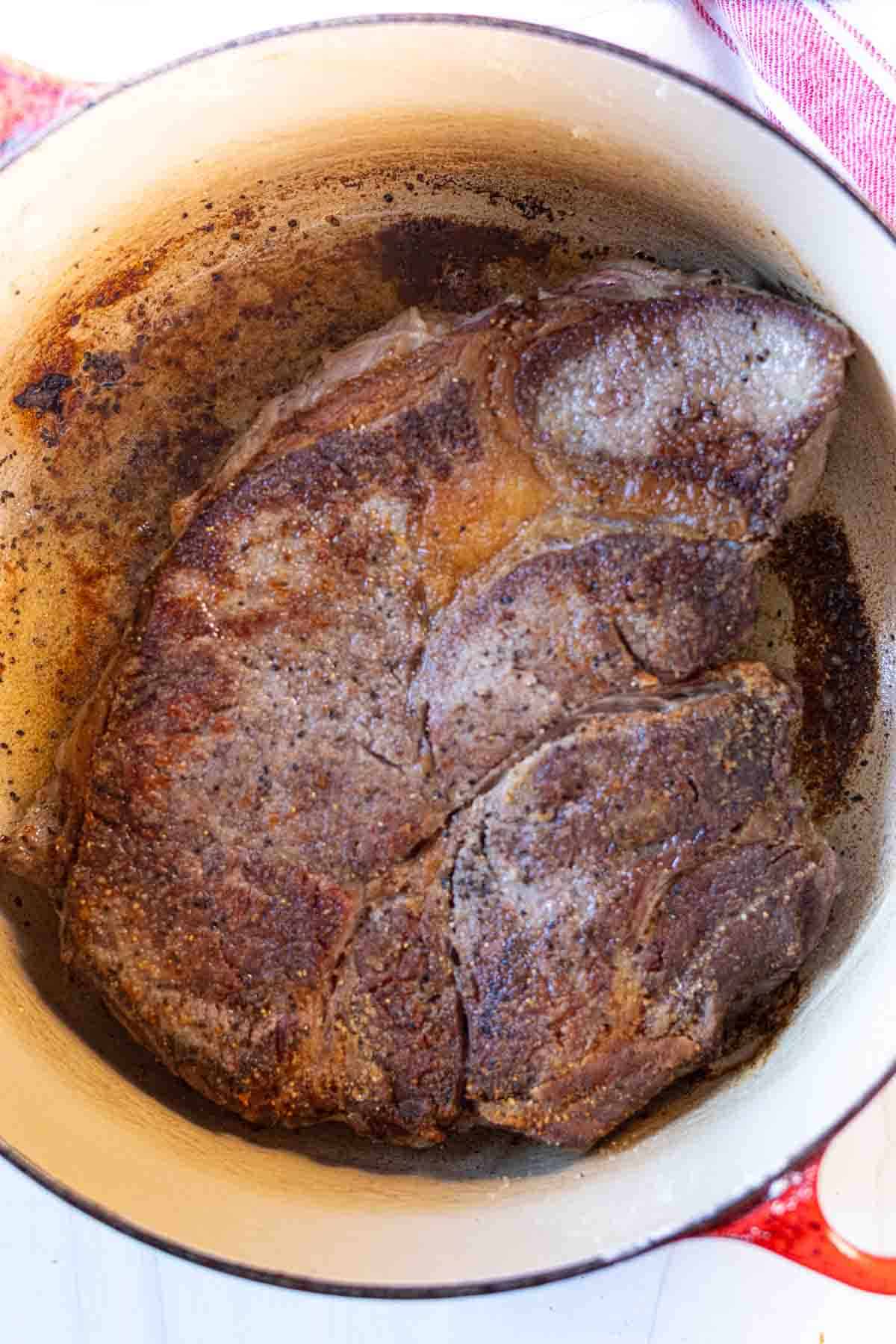 Searing roast beef to make pot roast dinner.