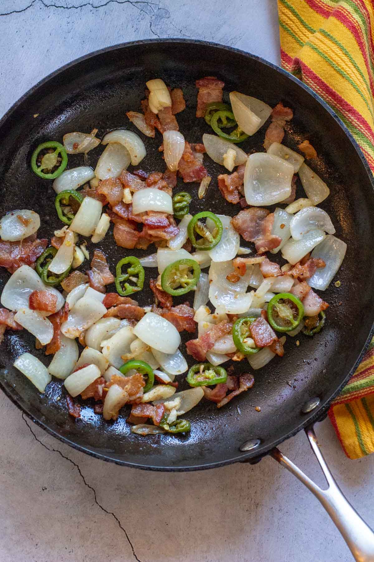 Cooking bacon and vegetables for Cowboy Beans.