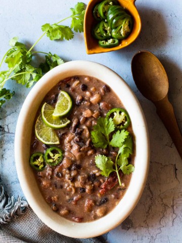 Cowboy Baked Beans recipe served in a white oval dish.