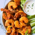 Buffalo shrimp with celery and blue cheese dipping sauce.