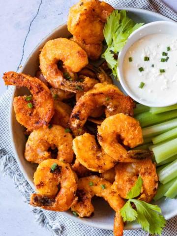 Buffalo shrimp with celery and blue cheese dipping sauce.