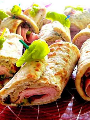 Pita roll sandwiches using deli meat and boursin cheese.