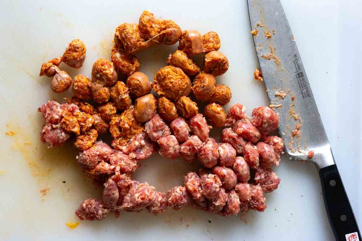 Step 1, cutting Italian sausage links to make Italian Sausage Soup.