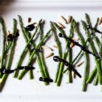 Sauteed asparagus drizzled with balsamic reduction sauce.