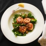 Seared Scallops with white wine butter sauce served over baby spinach.