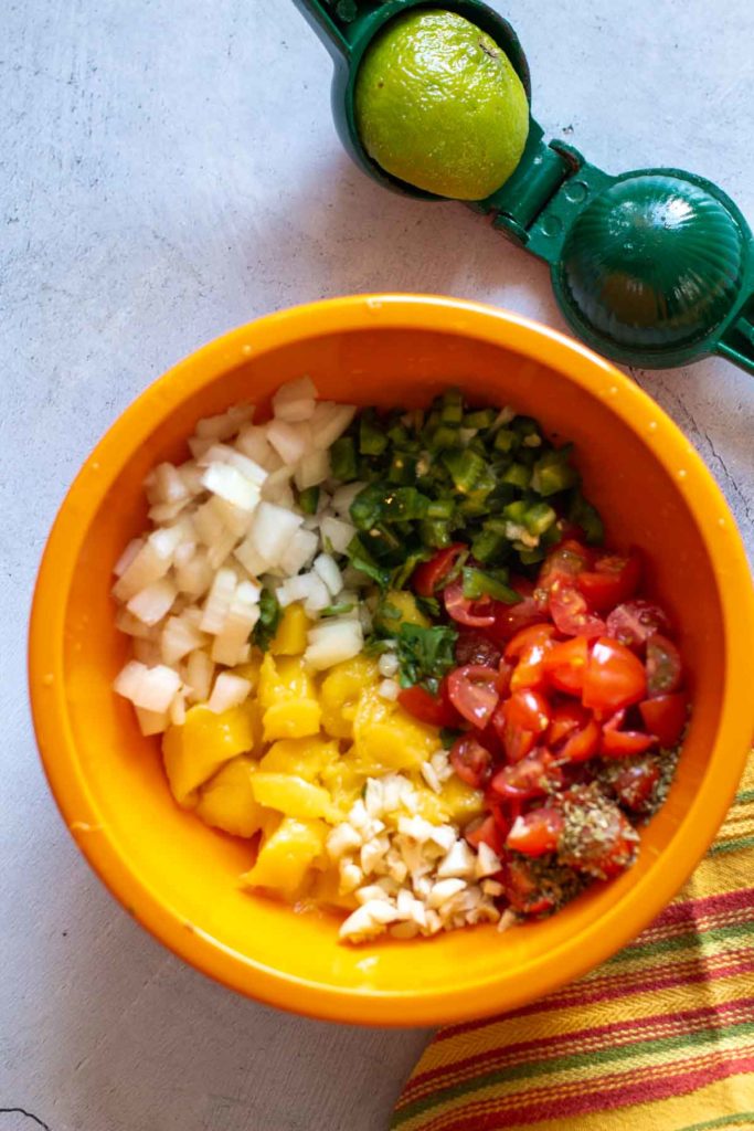 Chopped ingredients in a bowl to make pico de gallo.