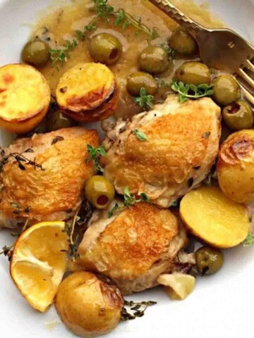 Braised chicken thighs with potatoes, lemons and olives.