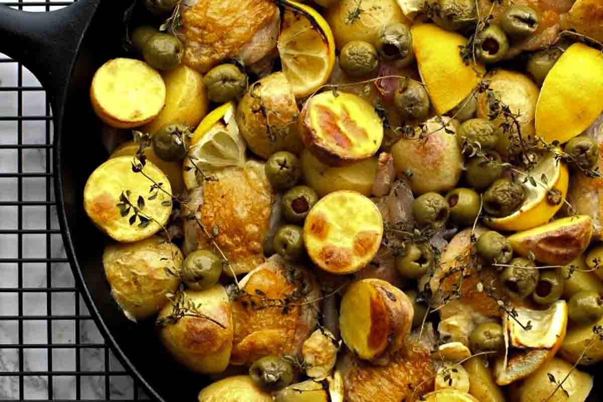 Oven braised chicken thighs with potatoes, lemon, olives and thyme
